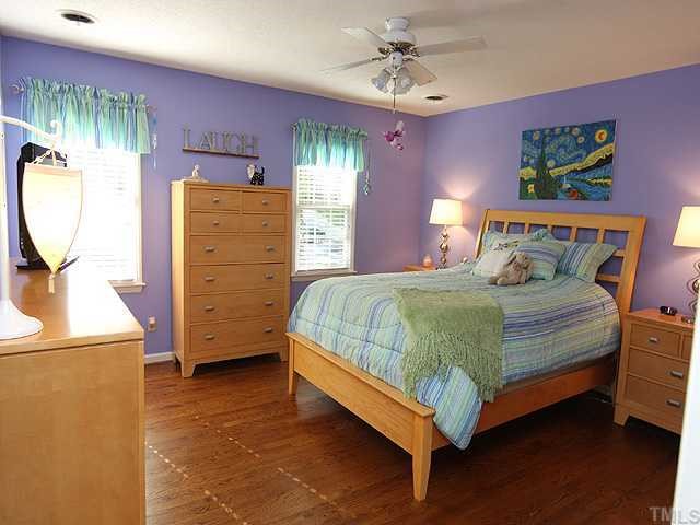 1109 Hunting Ridge Road Raleigh, NC 27615 - Photo 8 of 12 a bedroom with a bed and a dresser