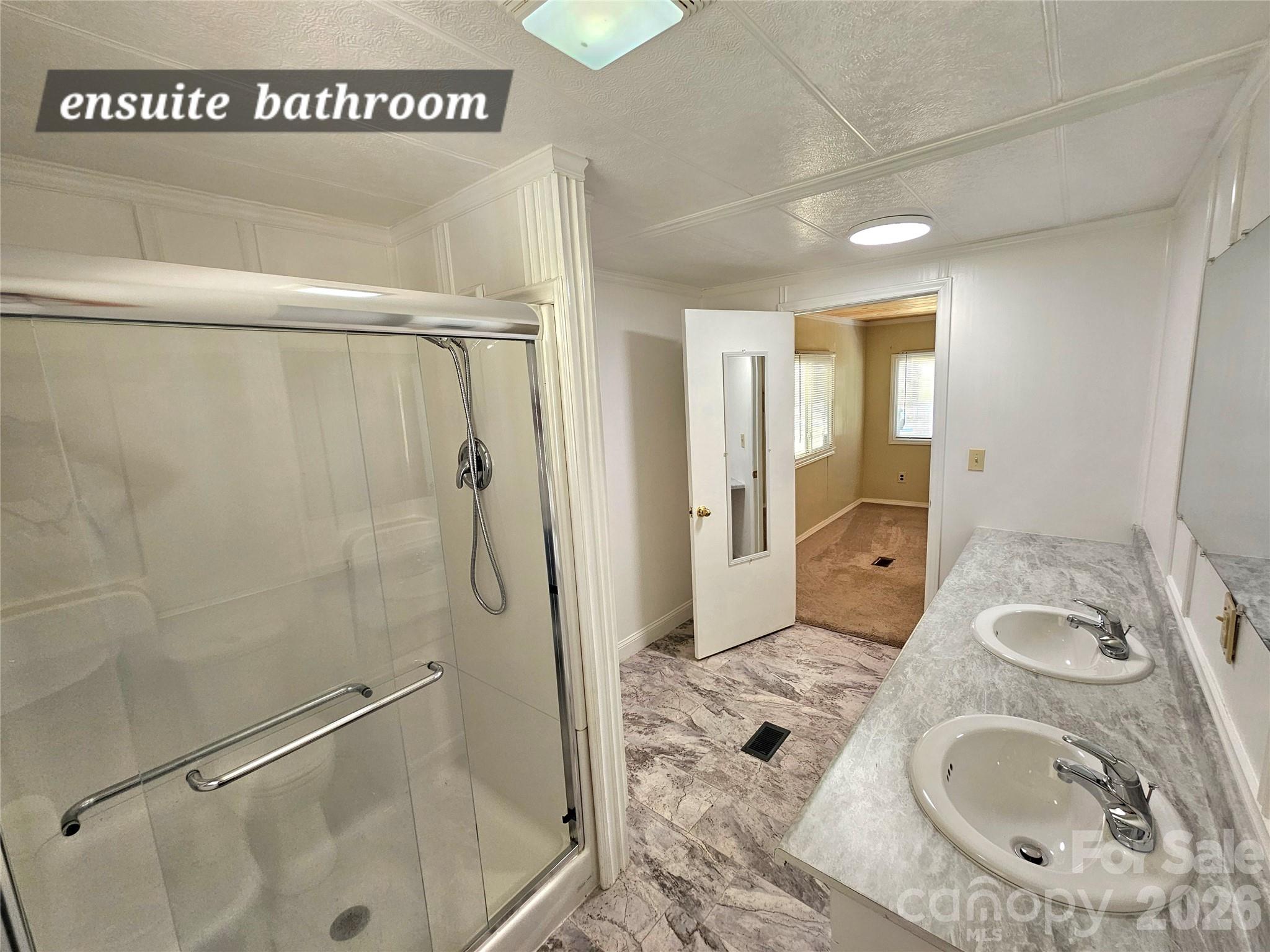 44716 Gold Branch Road Richfield, NC 28137 - Photo 28 of 47 a bathroom with a granite countertop sink a mirror and shower