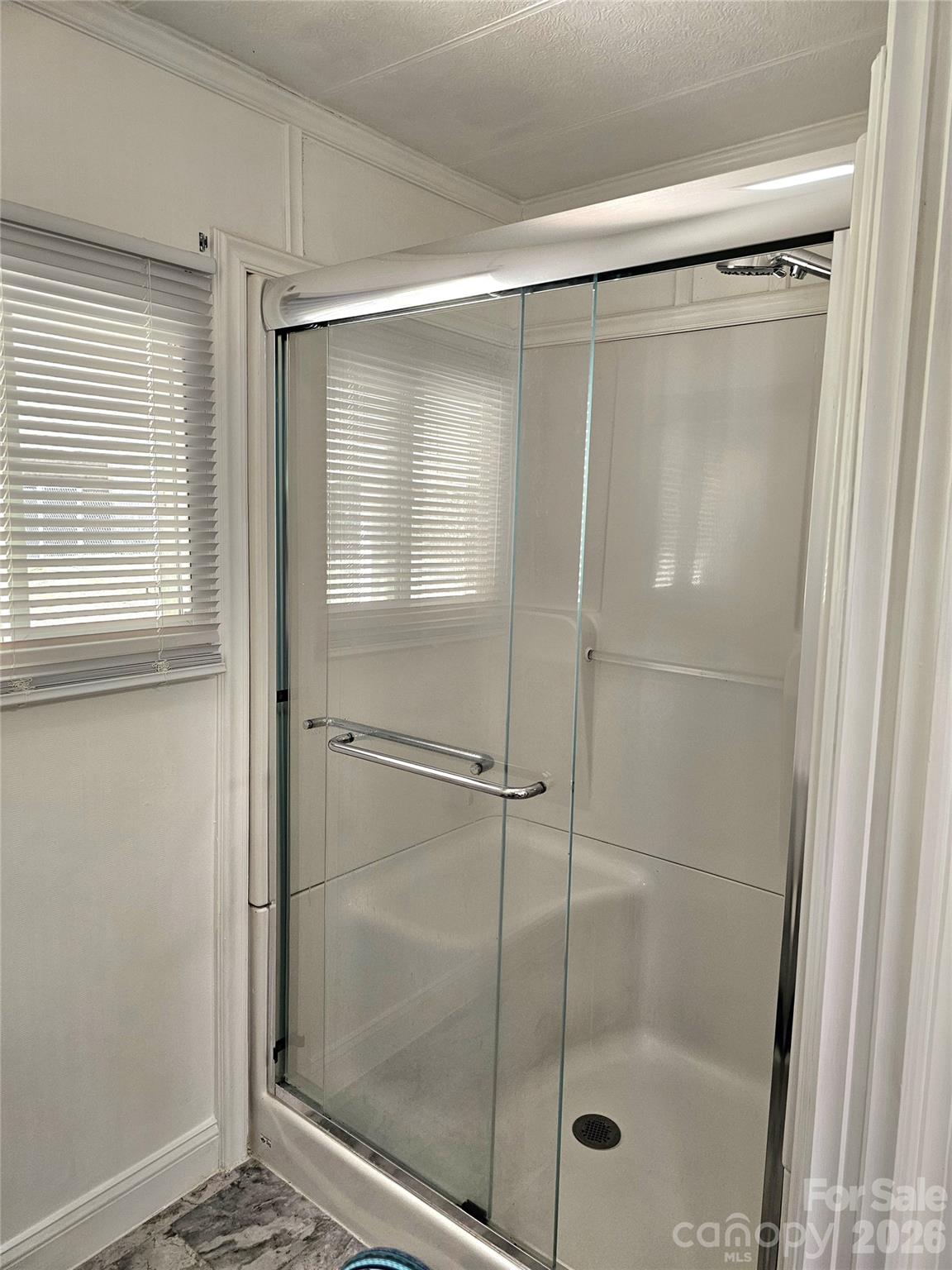 44716 Gold Branch Road Richfield, NC 28137 - Photo 29 of 47 a bathroom with a glass shower door