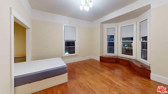 a bedroom with a bed and window