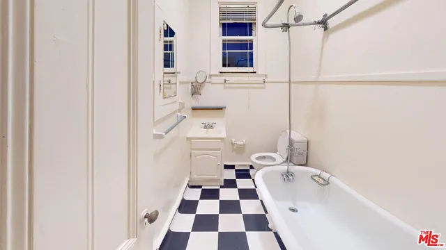 a bathroom with a sink a toilet and a shower