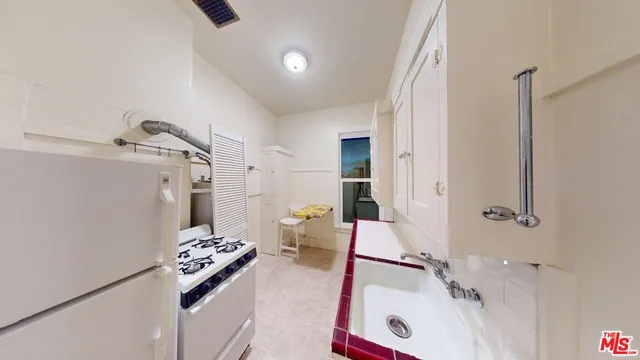 a bathroom with a tub sink and a mirror
