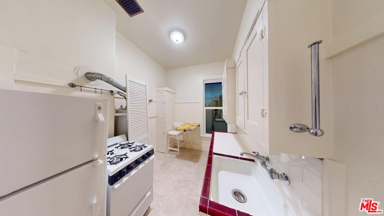 487 43rd Street, Unit 3 Oakland, CA 94609 - Photo 7 of 9 a bathroom with a tub sink and a mirror
