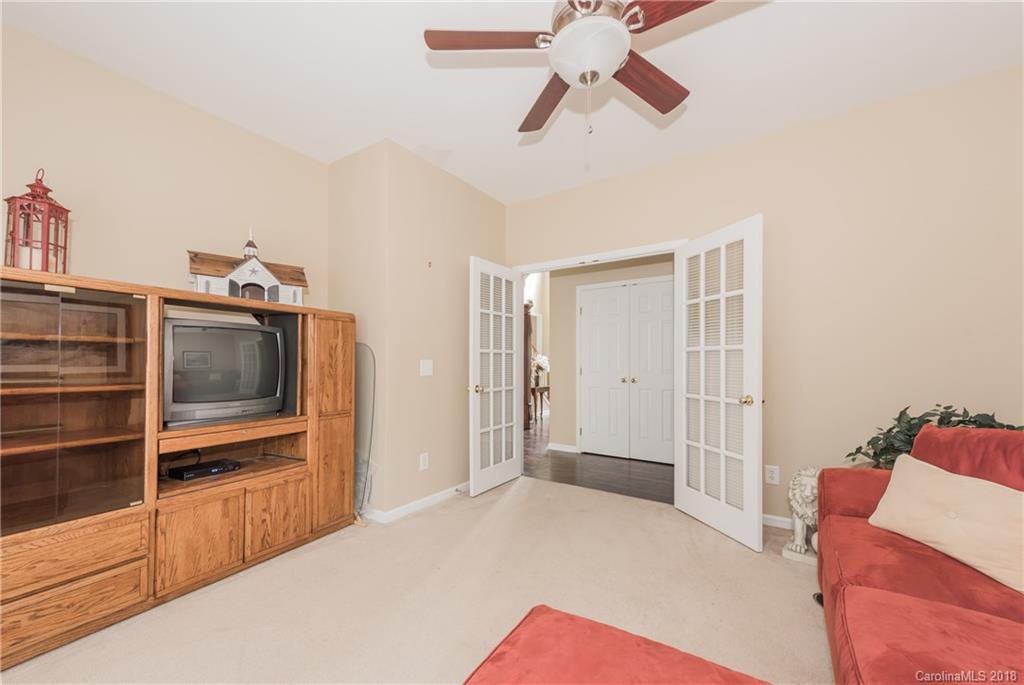 1942 Faison Avenue, Unit 161 Fort Mill, SC 29708 - Photo 12 of 21 a bedroom with a bed and a chandelier fan