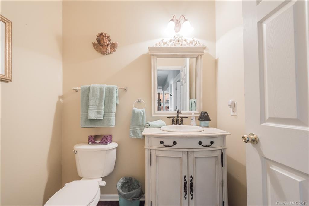 1942 Faison Avenue, Unit 161 Fort Mill, SC 29708 - Photo 13 of 21 a bathroom with a toilet sink and mirror