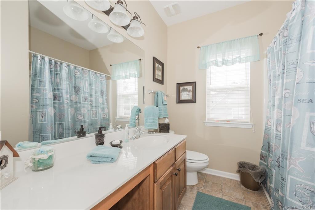 1942 Faison Avenue, Unit 161 Fort Mill, SC 29708 - Photo 16 of 21 a bathroom with a double vanity sink mirror and toilet