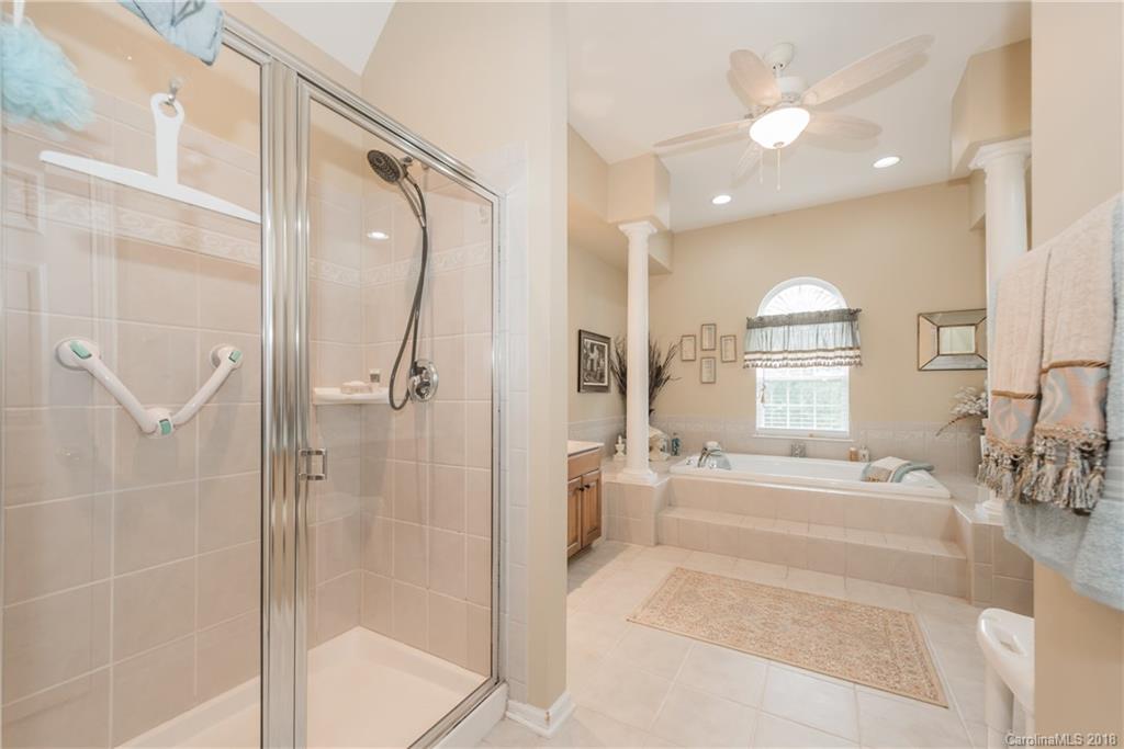 1942 Faison Avenue, Unit 161 Fort Mill, SC 29708 - Photo 18 of 21 a spacious bathroom with a bathtub shower and a sink