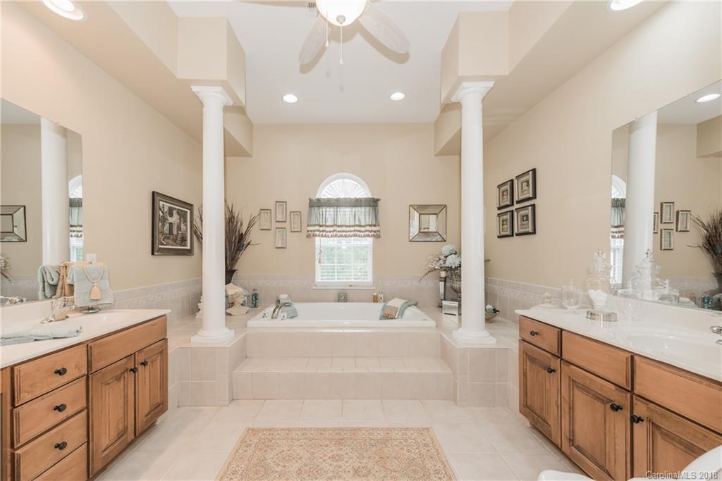 1942 Faison Avenue, Unit 161 Fort Mill, SC 29708 - Photo 19 of 21 a spacious bathroom with double vanity a mirror a double vanity sinks and a bathtub