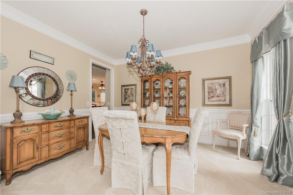 1942 Faison Avenue, Unit 161 Fort Mill, SC 29708 - Photo 4 of 21 a living room with furniture a clock and a chandelier