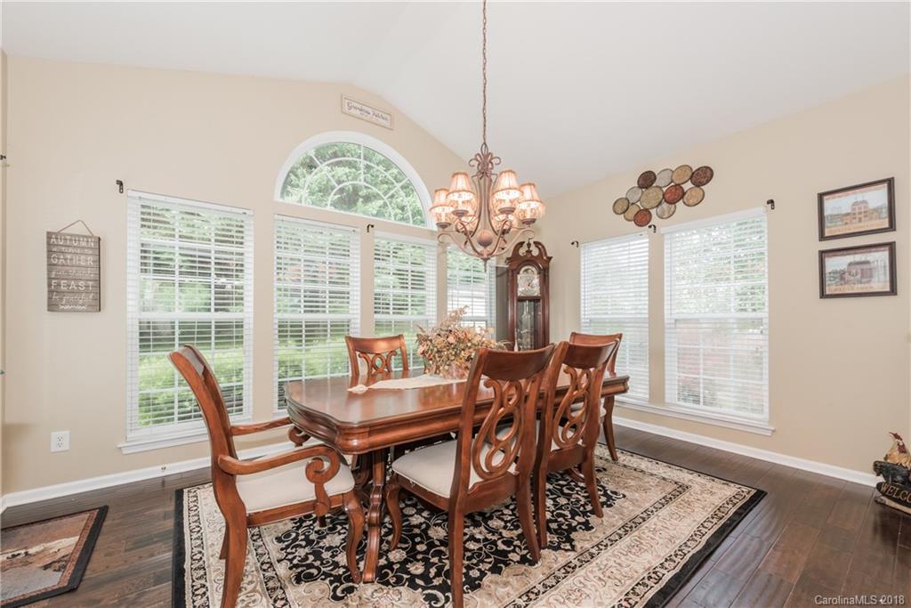 1942 Faison Avenue, Unit 161 Fort Mill, SC 29708 - Photo 9 of 21 a view of a dining room with furniture a chandelier and wooden floor