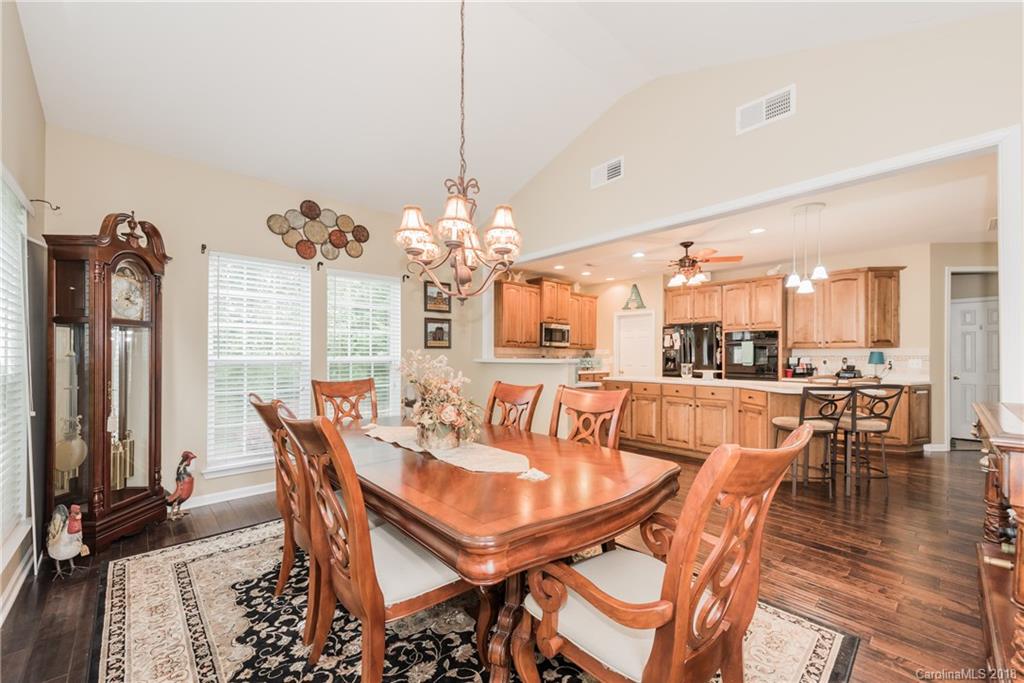 1942 Faison Avenue, Unit 161 Fort Mill, SC 29708 - Photo 10 of 21 a view of a dining room with furniture and chandelier
