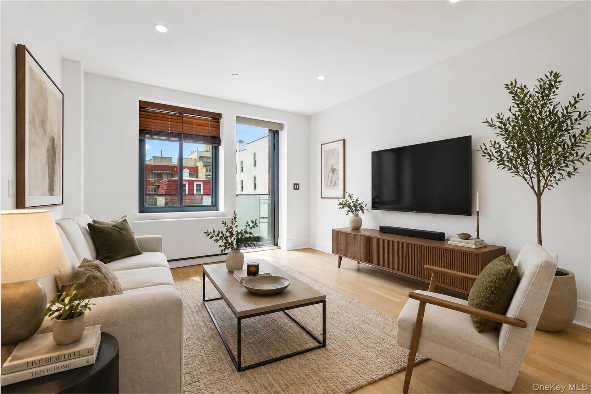 23-43 31st Road, Unit 3B Queens, NY 11106 - Photo 1 of 15 a living room with furniture and a flat screen tv