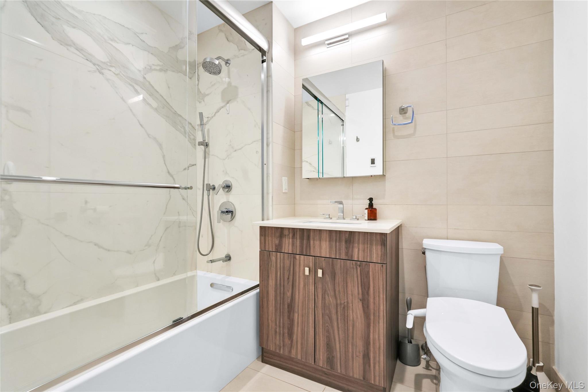 23-43 31st Road, Unit 3B Queens, NY 11106 - Photo 12 of 15 a bathroom with a sink a toilet and a bathtub