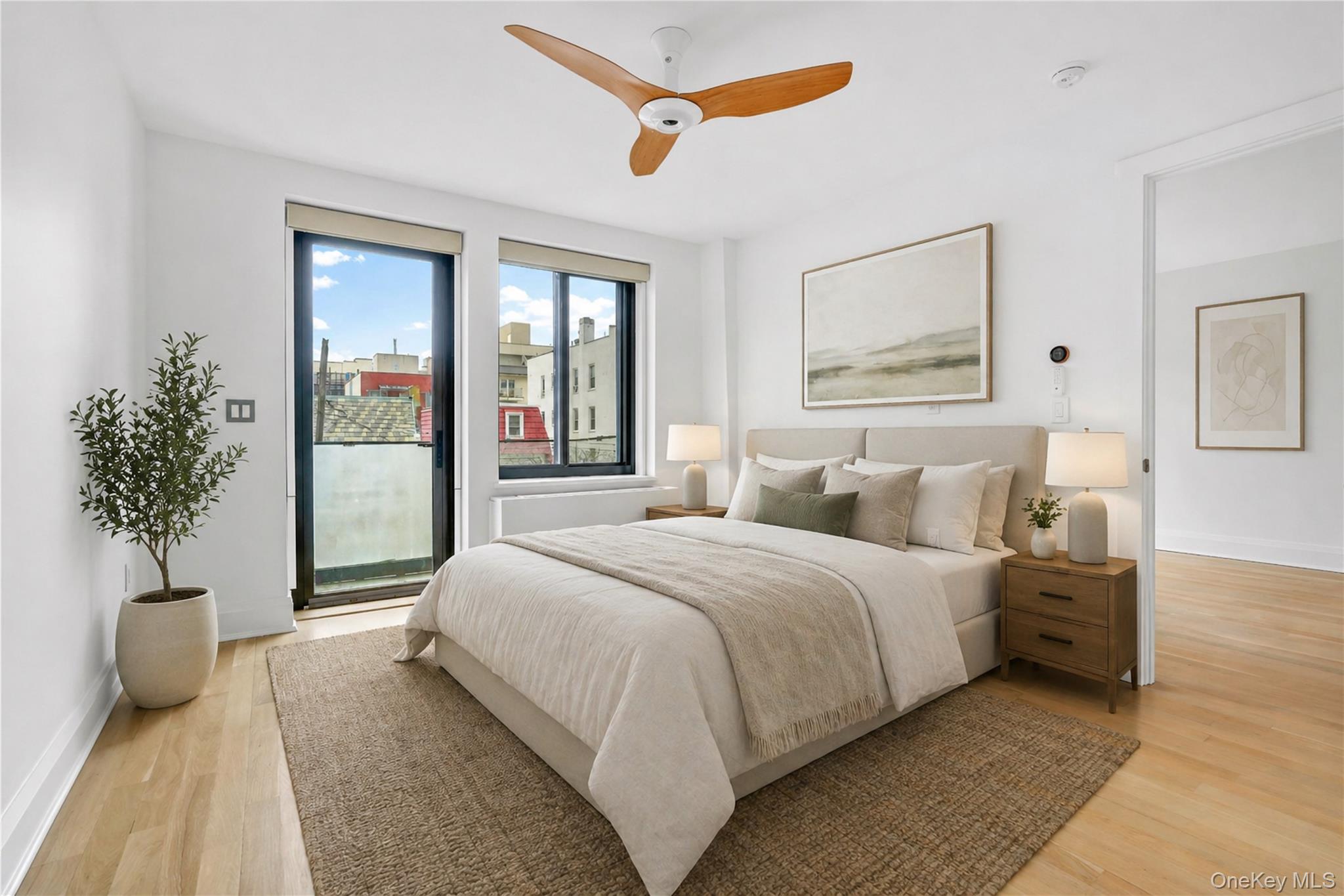 23-43 31st Road, Unit 3B Queens, NY 11106 - Photo 4 of 15 a bedroom with a large bed and a potted plant