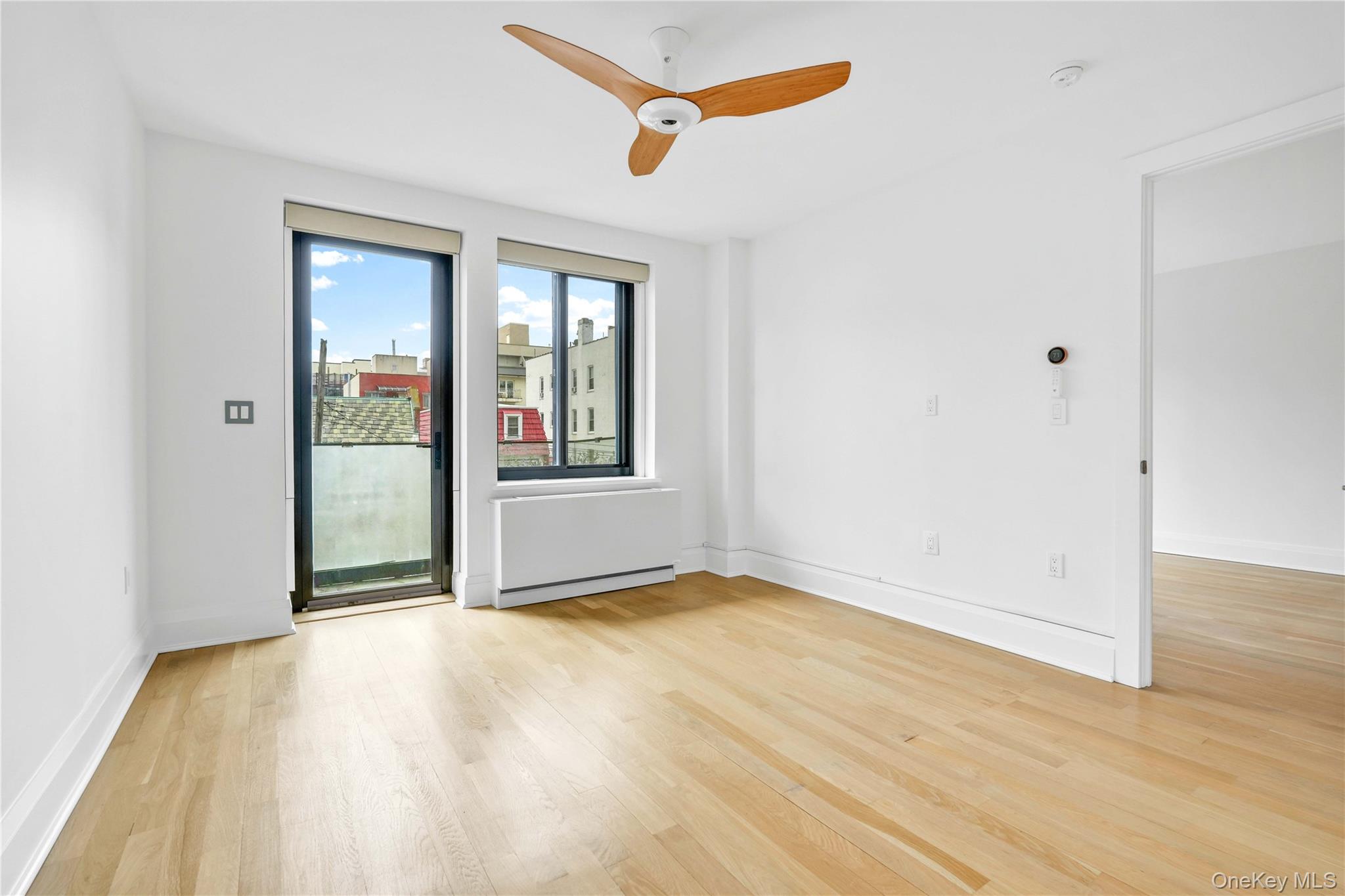 23-43 31st Road, Unit 3B Queens, NY 11106 - Photo 5 of 15 a view of an empty room with glass door