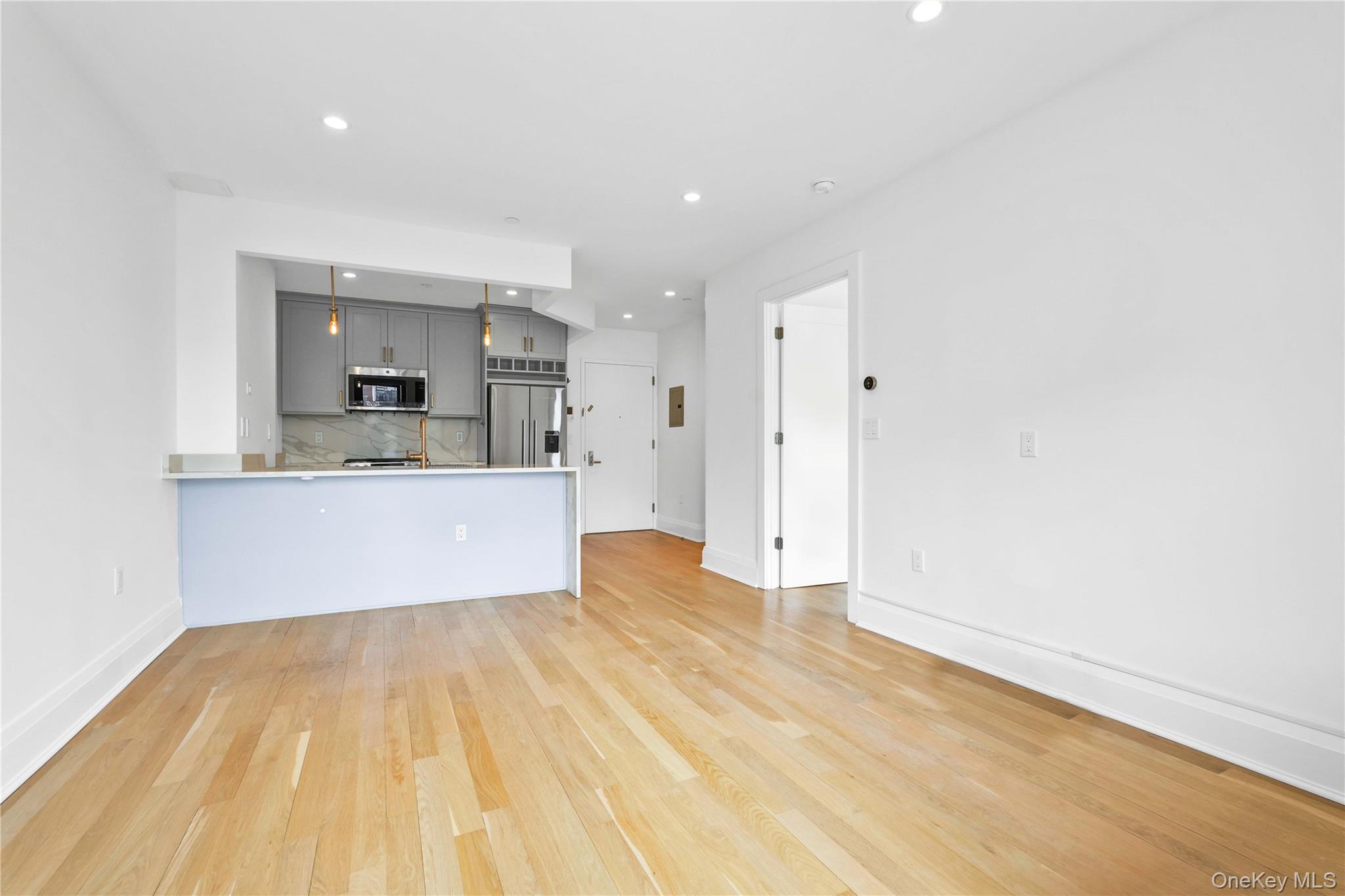 23-43 31st Road, Unit 3B Queens, NY 11106 - Photo 8 of 15 a view of kitchen with cabinets and wooden floor