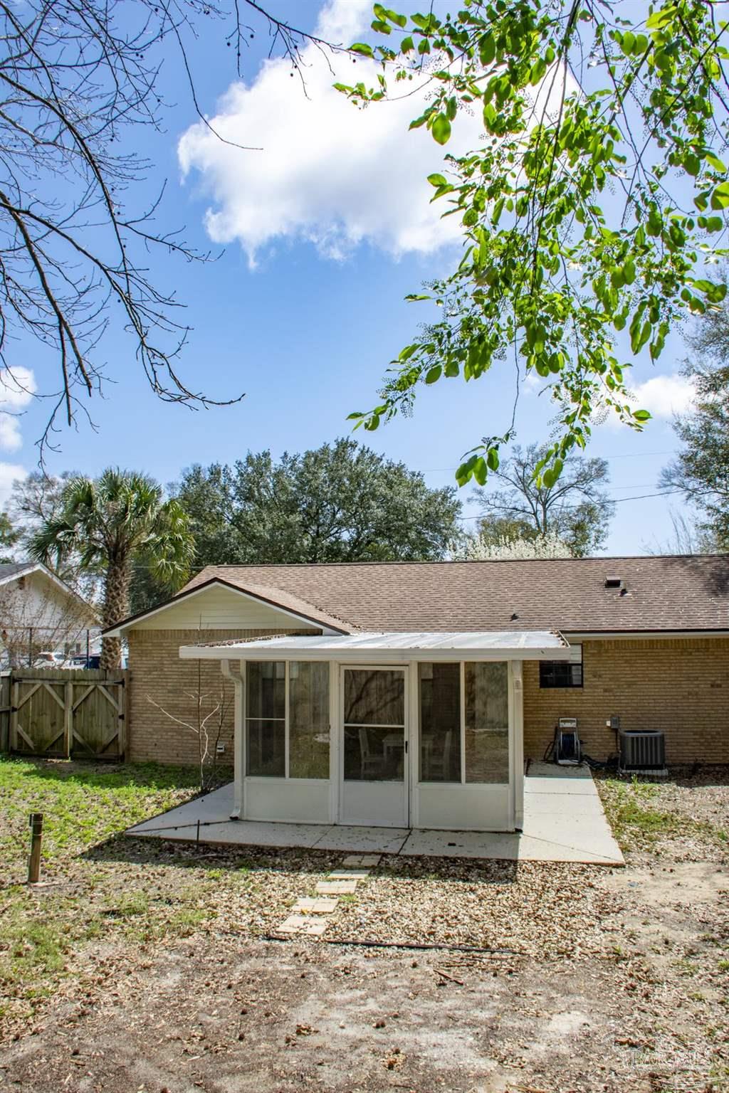 6514 Oakcrest Road Milton, FL 32570 - Photo 12 of 68 a front view of a house with a yard