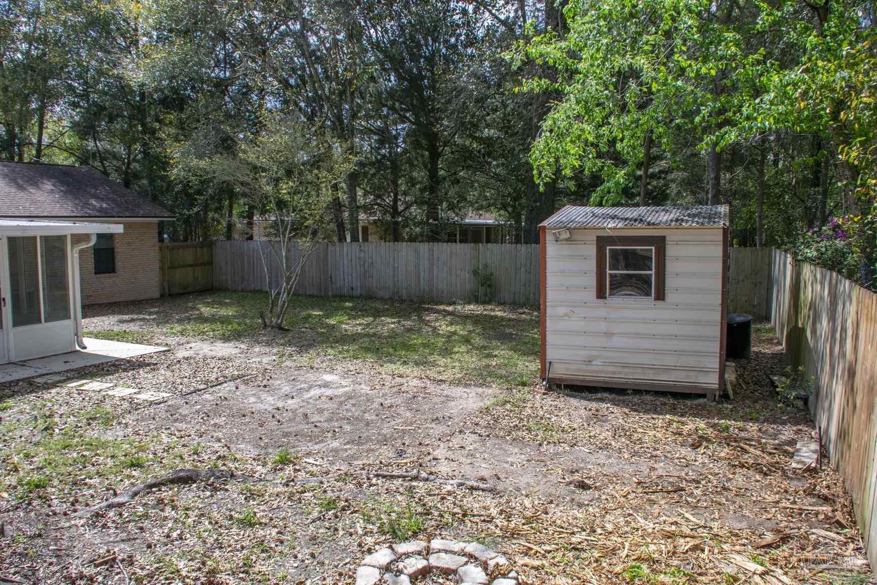 6514 Oakcrest Road Milton, FL 32570 - Photo 13 of 68 a view of a backyard