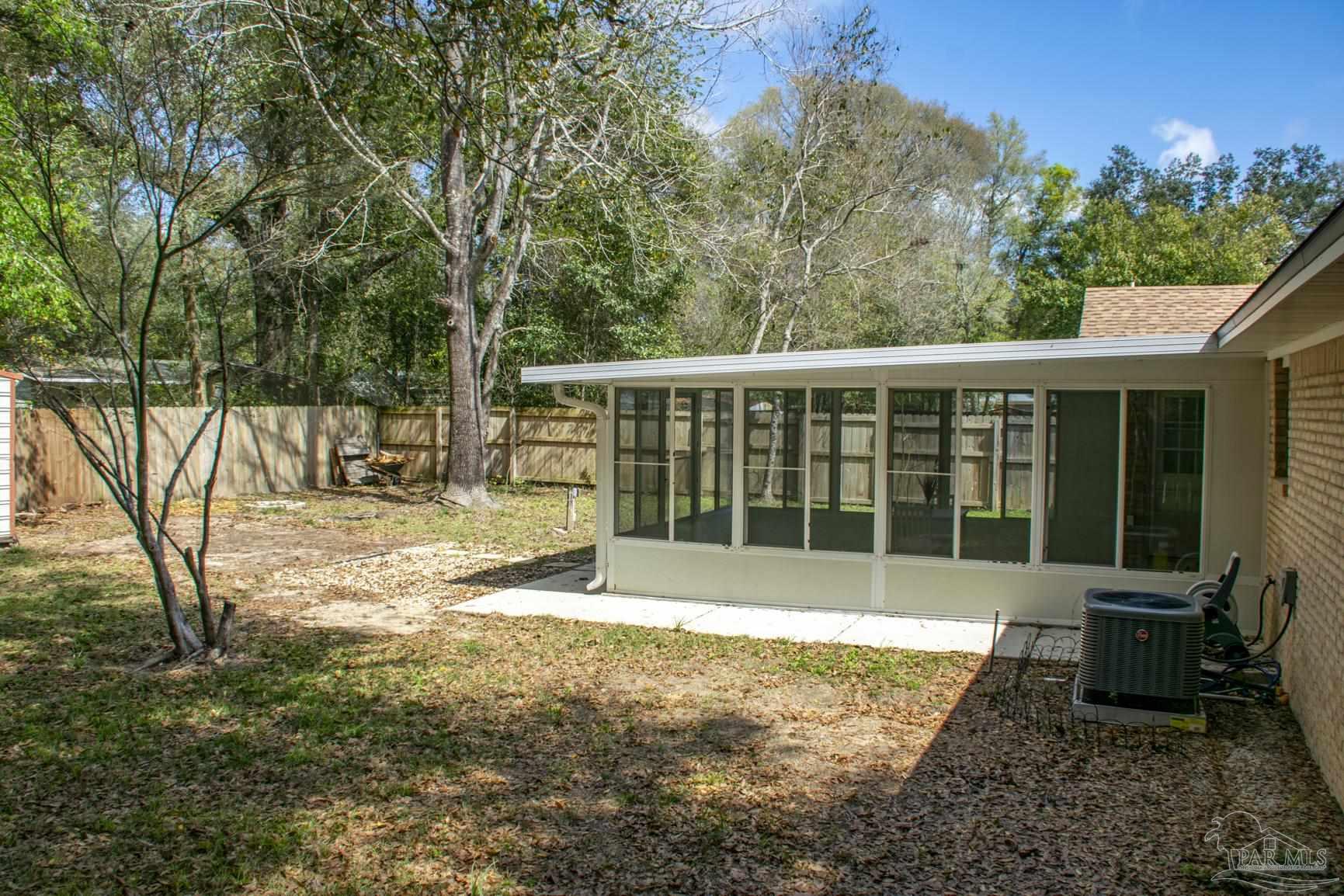 6514 Oakcrest Road Milton, FL 32570 - Photo 17 of 68 a view of a house with backyard and sitting area