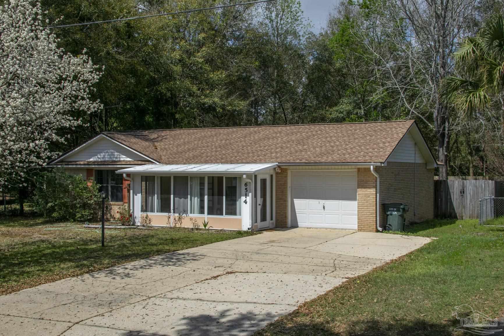 6514 Oakcrest Road Milton, FL 32570 - Photo 2 of 68 a front view of a house with a yard and trees