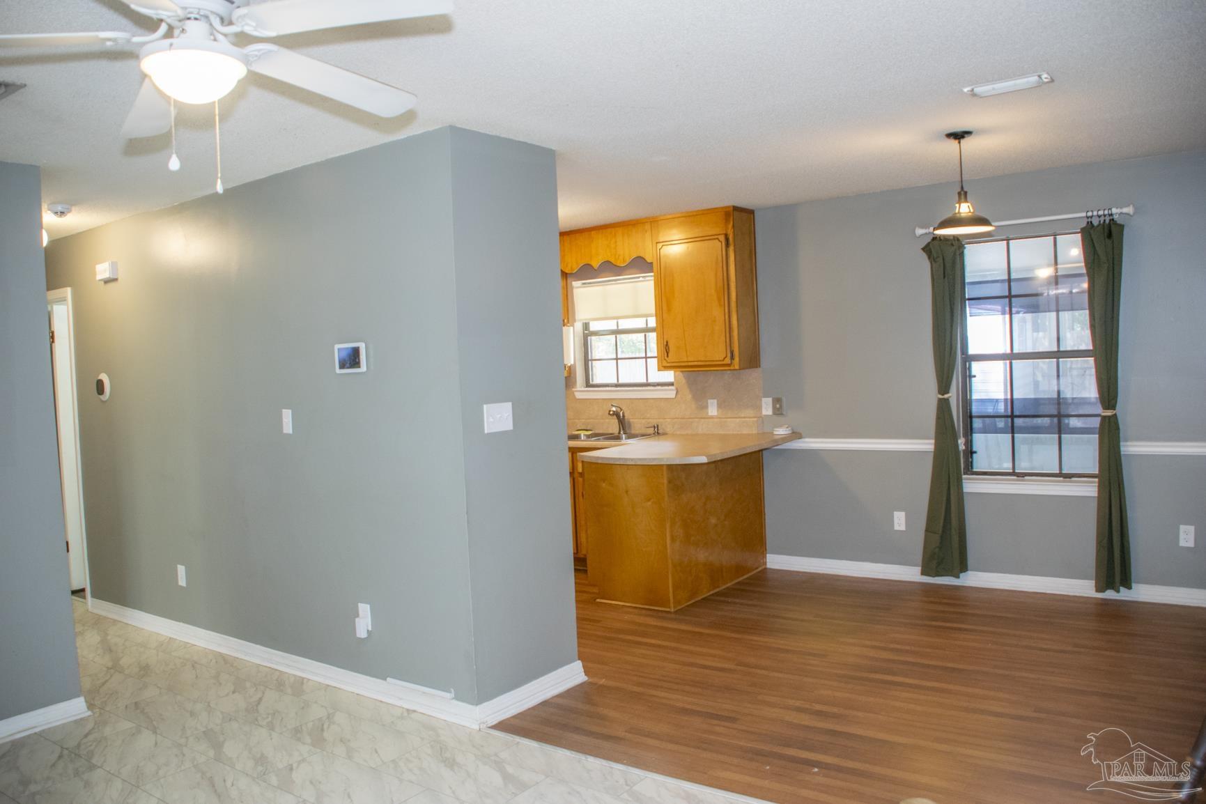 6514 Oakcrest Road Milton, FL 32570 - Photo 26 of 68 a view of a kitchen with a sink and wooden floor