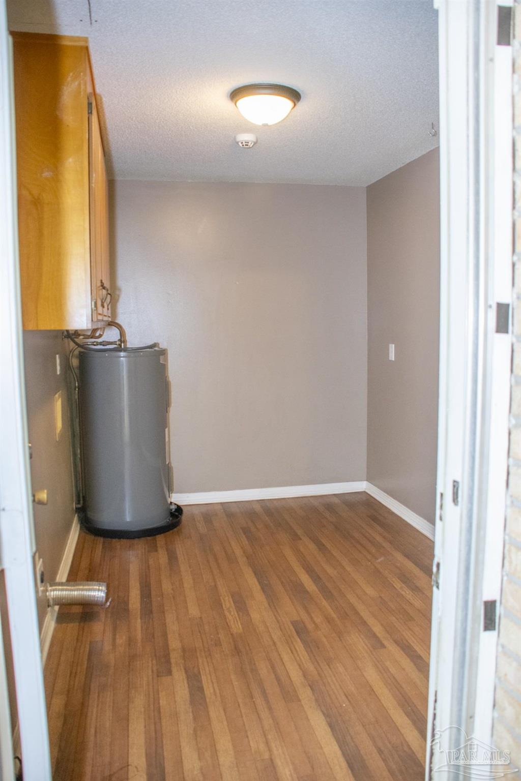 6514 Oakcrest Road Milton, FL 32570 - Photo 38 of 68 a view of an empty room with wooden floor and a window