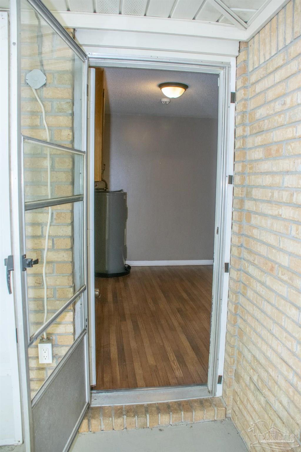 6514 Oakcrest Road Milton, FL 32570 - Photo 39 of 68 a view of walk in closet with wooden floor