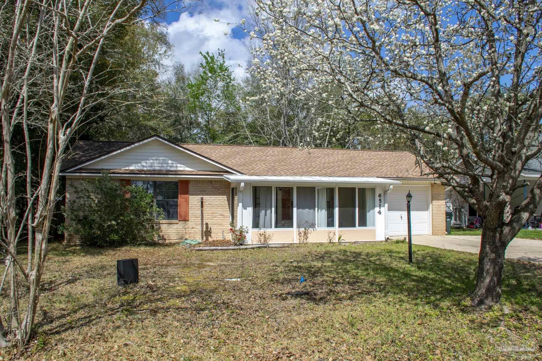 6514 Oakcrest Road Milton, FL 32570 - Photo 4 of 68 a front view of a house with a yard