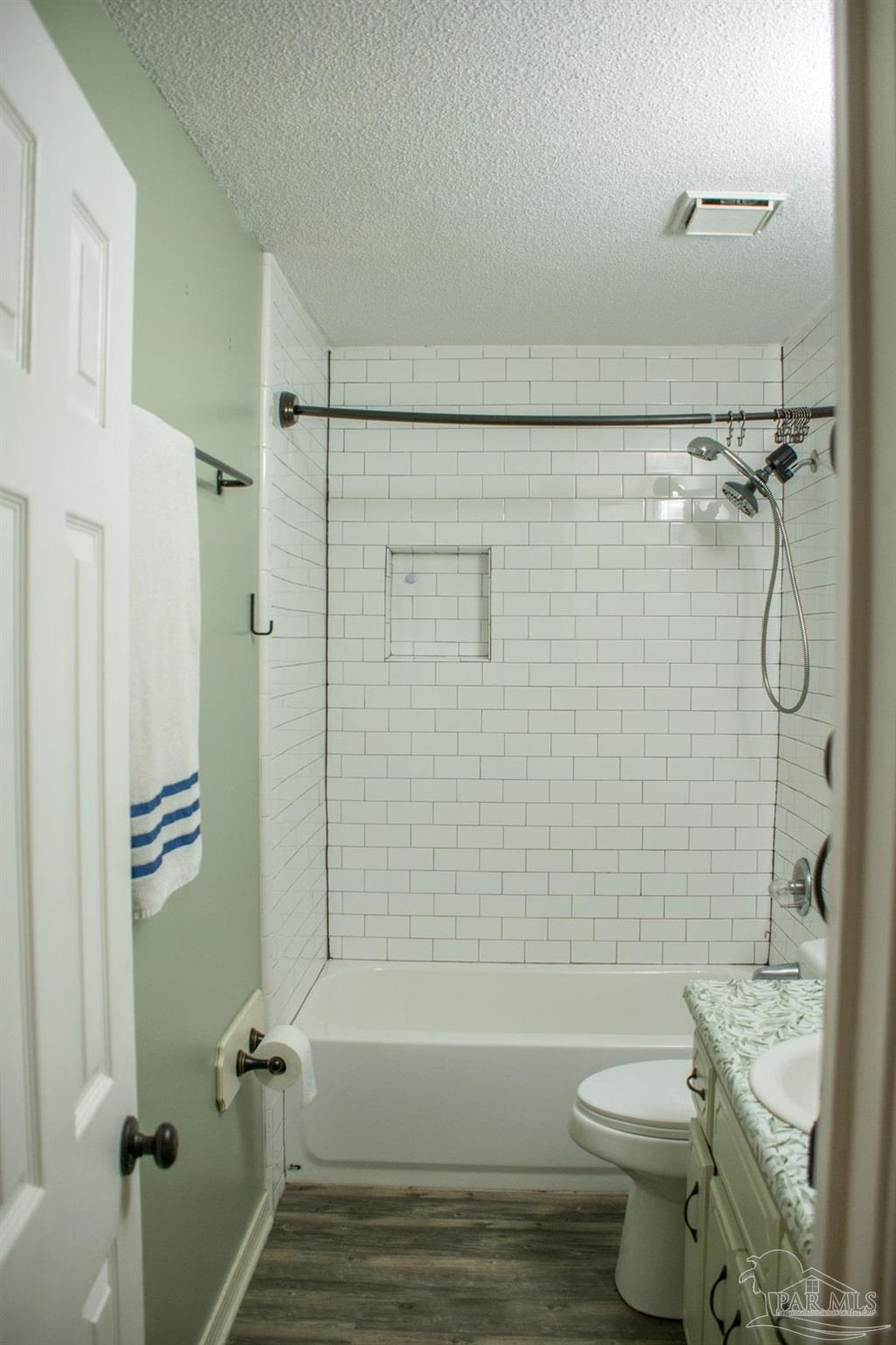 6514 Oakcrest Road Milton, FL 32570 - Photo 41 of 68 a bathroom with a shower a toilet and bathtub