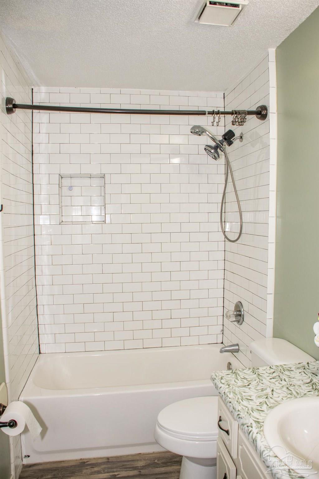 6514 Oakcrest Road Milton, FL 32570 - Photo 43 of 68 a bathroom with a granite countertop bathtub shower sink vanity and toilet