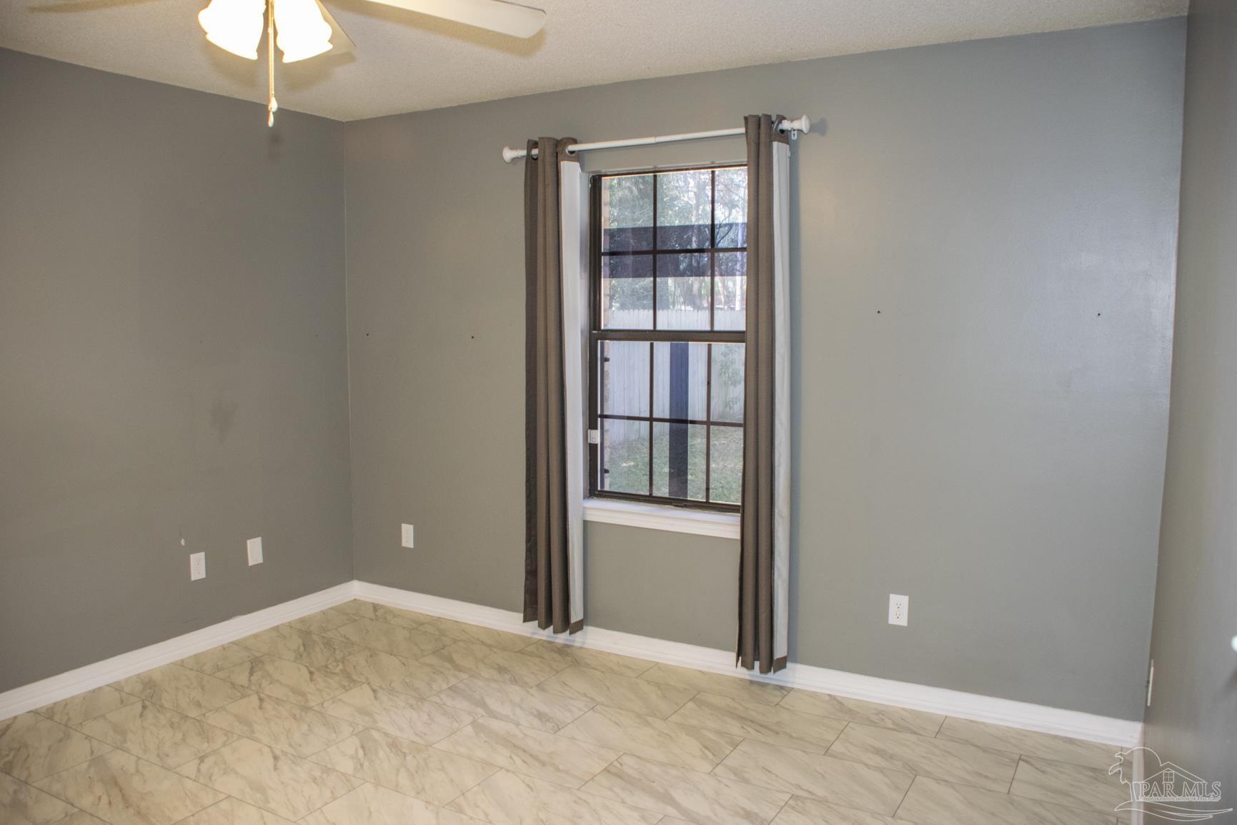 6514 Oakcrest Road Milton, FL 32570 - Photo 48 of 68 an empty room with closet and a chandelier fan