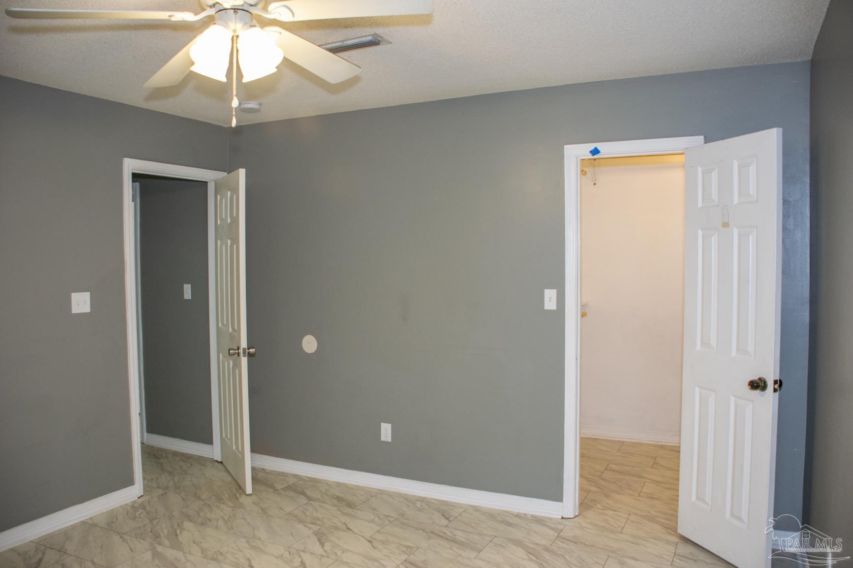 6514 Oakcrest Road Milton, FL 32570 - Photo 50 of 68 a view of an empty room and chandelier fan