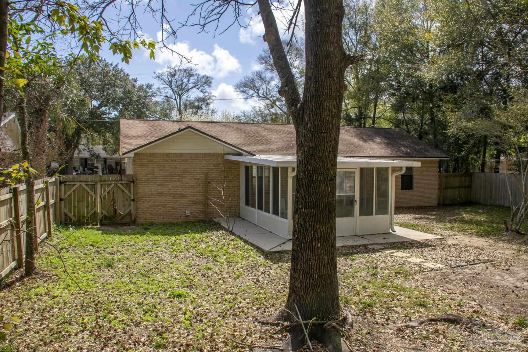 6514 Oakcrest Road Milton, FL 32570 - Photo 10 of 68 a front view of a house with a yard and garage