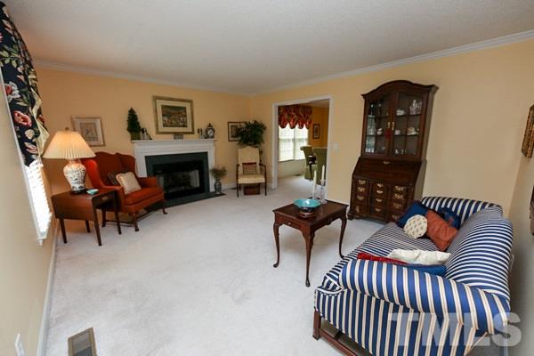 5409 Staysail Court Raleigh, NC 27613 - Photo 3 of 20 a living room with furniture a fireplace and a flat screen tv