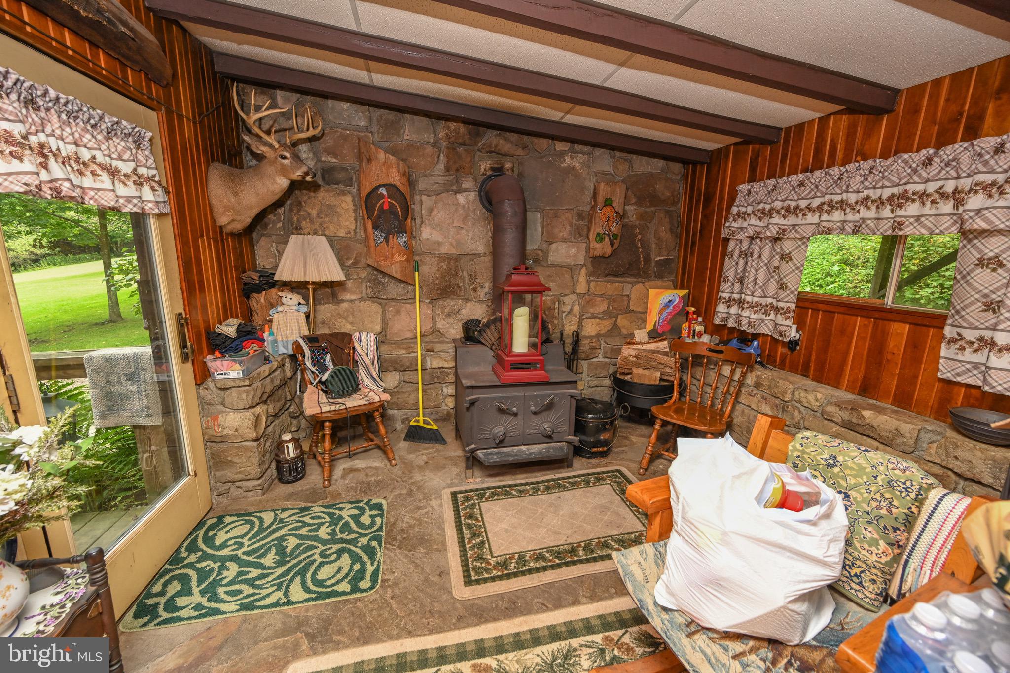 2527 Pigs Ear Road Grantsville, MD 21536 - Photo 12 of 94 a living room with patio furniture and a floor to ceiling window