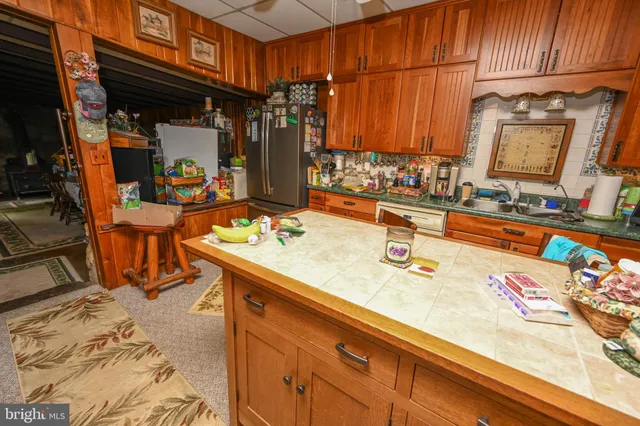a bedroom with bed and a flat tv screen on dresser