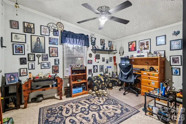 a view of a livingroom with workspace and toys