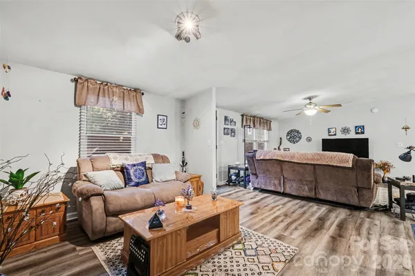 a living room with furniture and a wooden floor