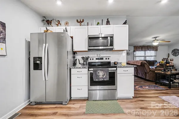 a kitchen with stainless steel appliances a refrigerator stove and microwave