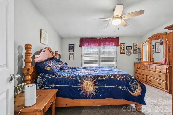a bed room with a bed and a window