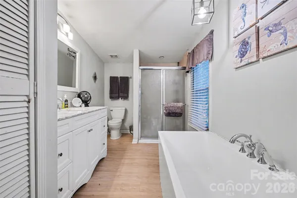 a bathroom with a tub sink and mirror