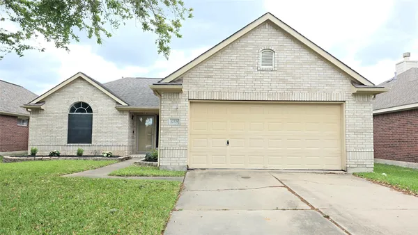 a view of a yard in front view of a house