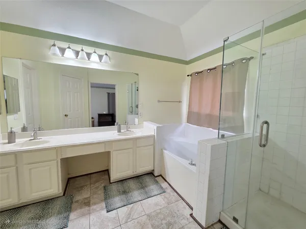 a bathroom with a double vanity sink mirror and shower