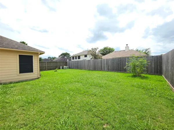 a view of yard with swimming pool and green space