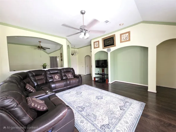 a living room with furniture and wooden floor