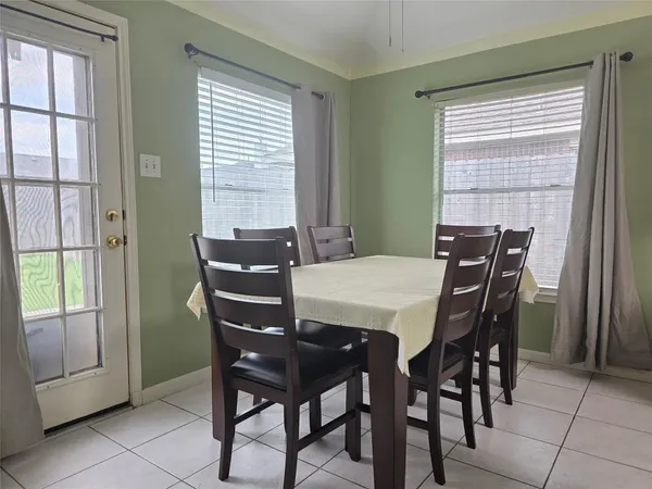 a view of a dining room with furniture and a window