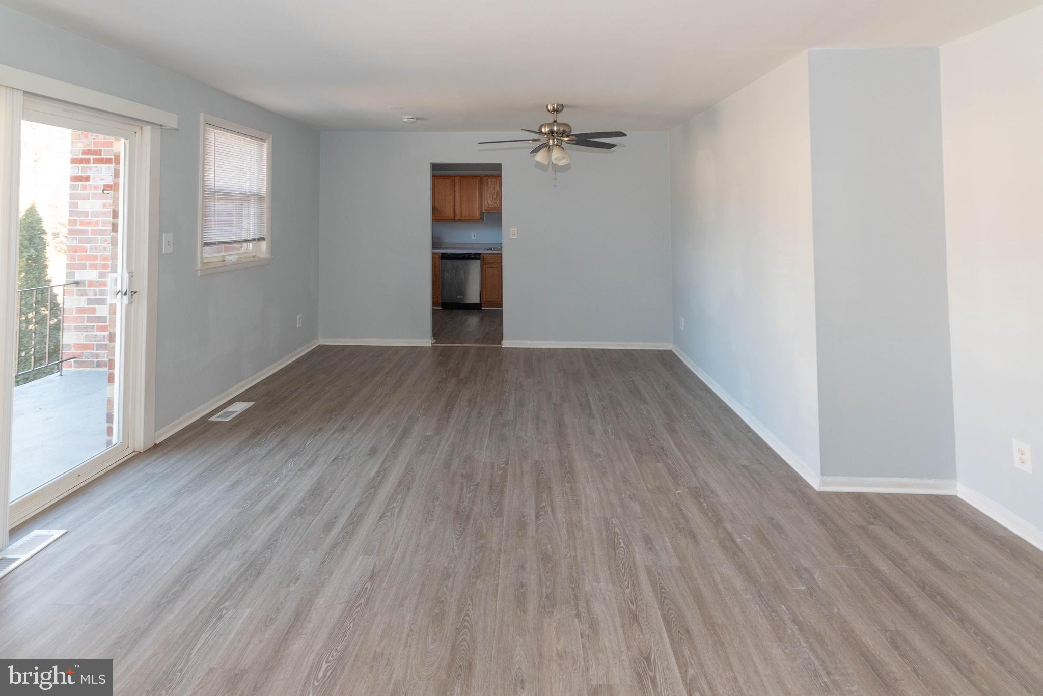 3712 Mayberry Avenue, Unit E Baltimore, MD 21206 - Photo 2 of 22 an empty room with wooden floor and windows