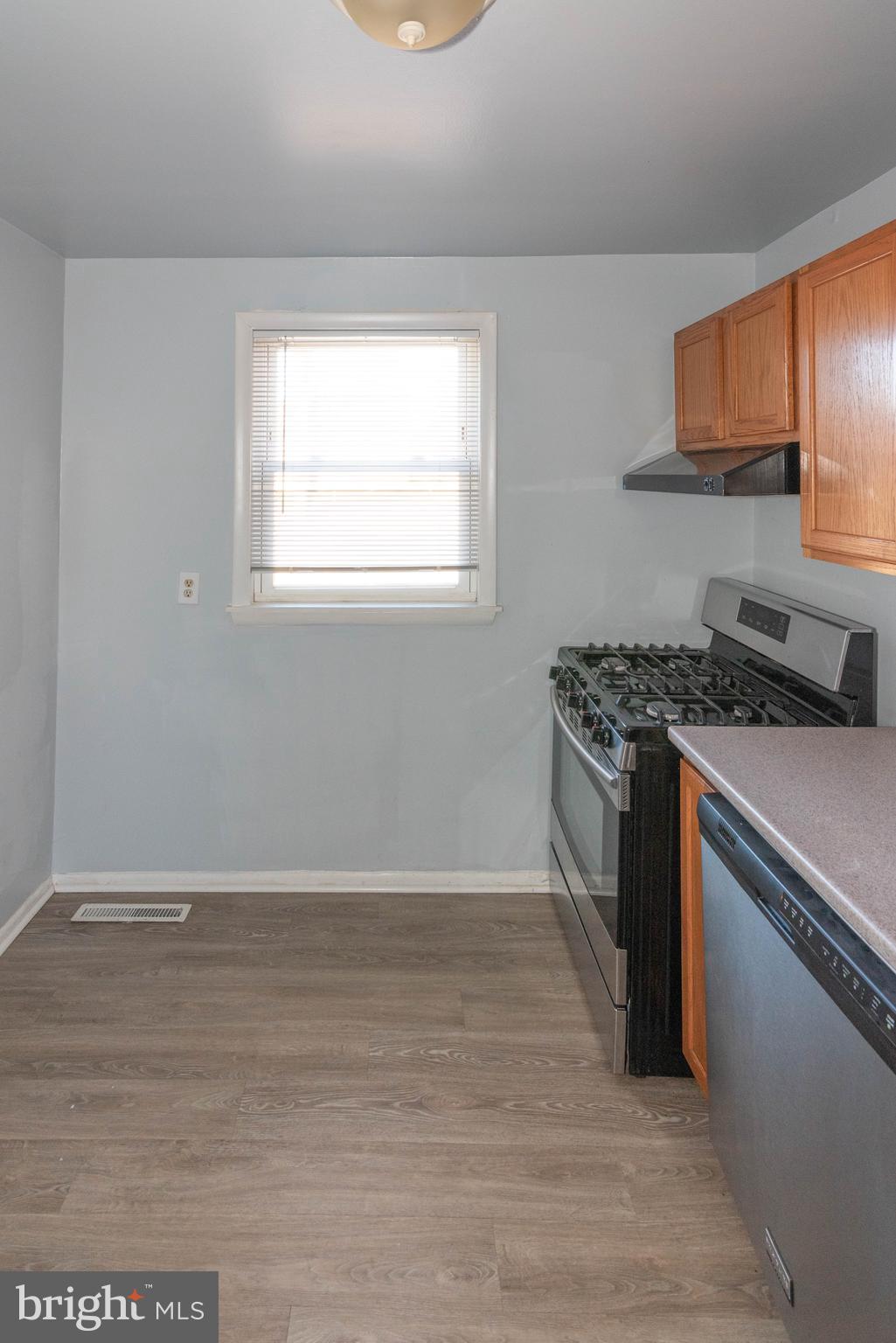 3712 Mayberry Avenue, Unit E Baltimore, MD 21206 - Photo 6 of 22 a kitchen with granite countertop a stove a sink and a refrigerator