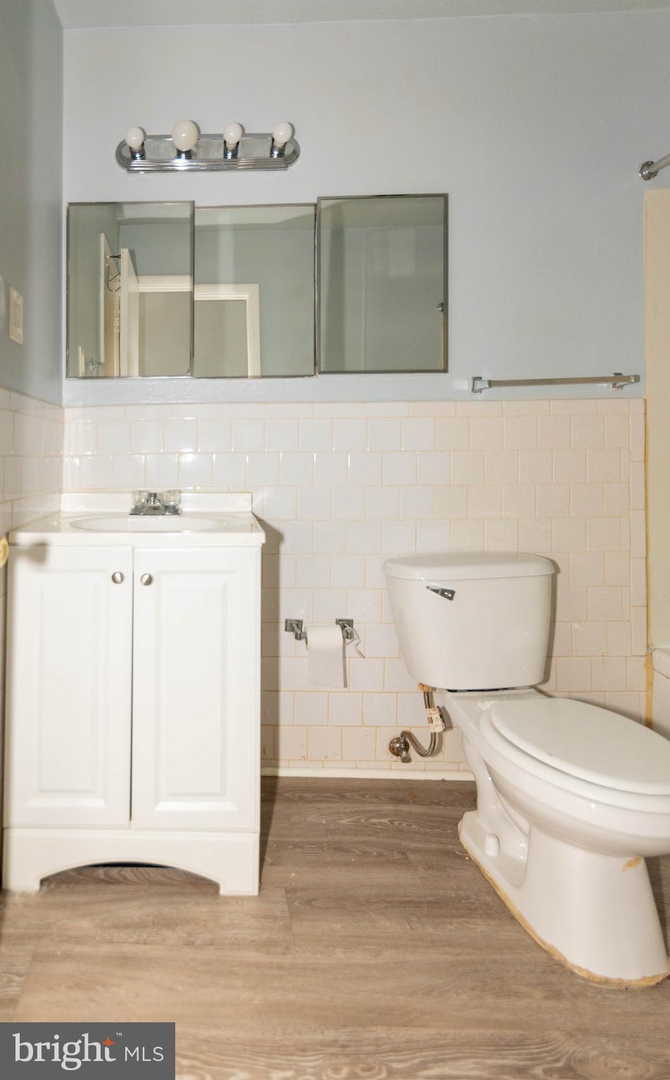 3712 Mayberry Avenue, Unit E Baltimore, MD 21206 - Photo 10 of 22 a bathroom with a toilet a sink and vanity