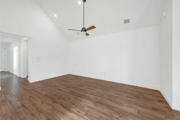 a large kitchen with stainless steel appliances kitchen island a large counter top a sink a stove and a refrigerator